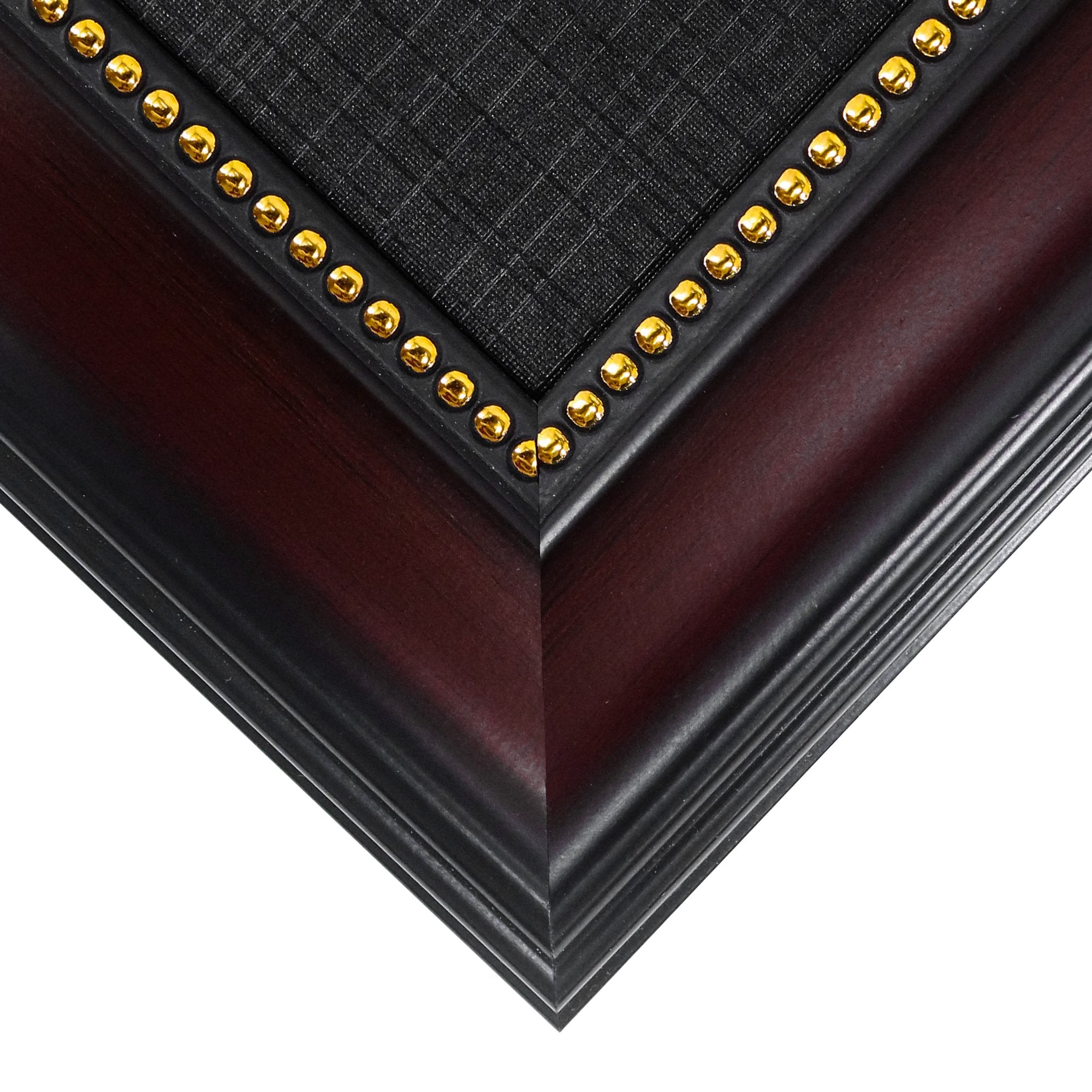 Close-up of a diploma frame corner showing mahogany finish wood, black accent, and gold decorative studs.