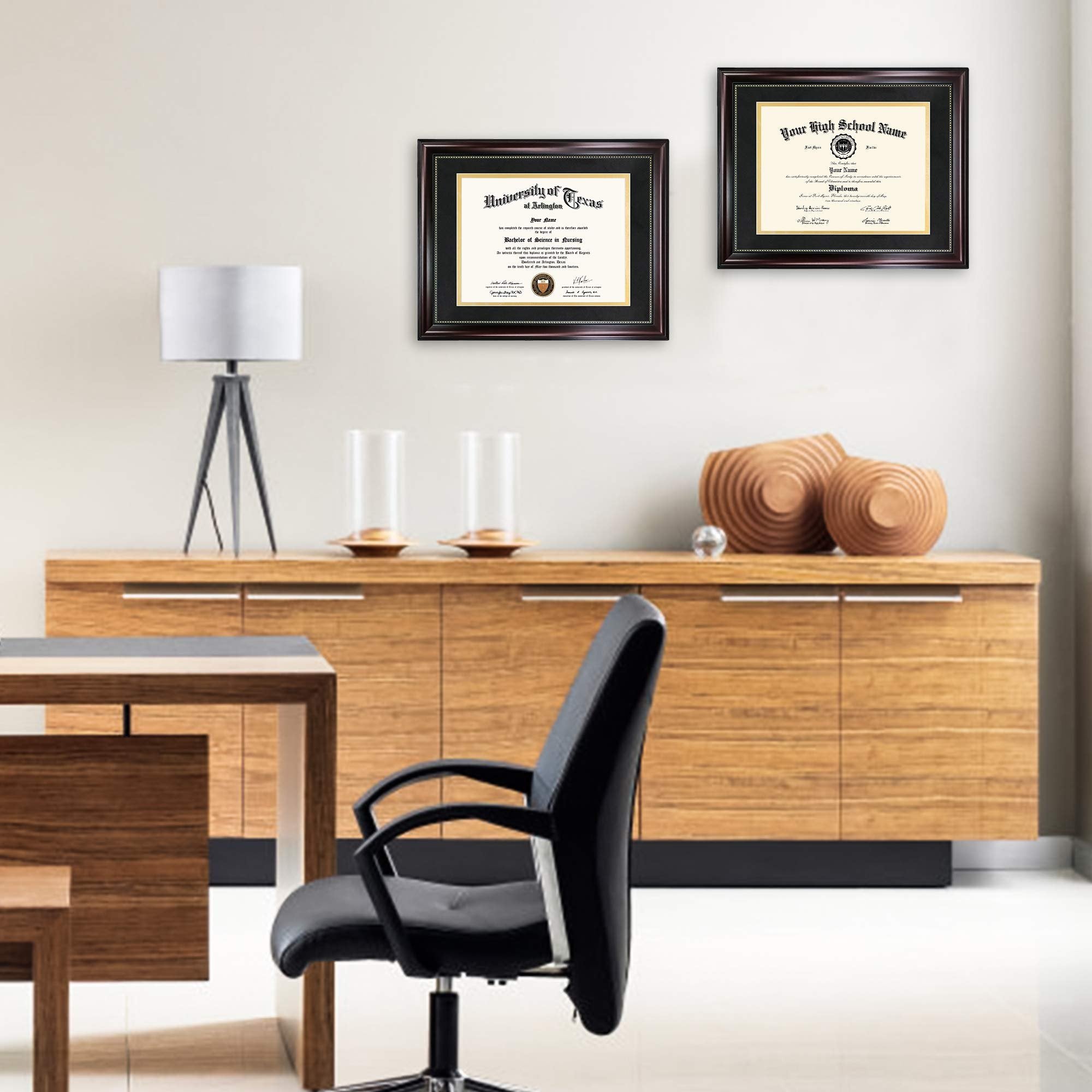 Two diploma frames hanging on a wall above a wooden credenza, one displaying a University of Texas diploma and the other a high school diploma.
