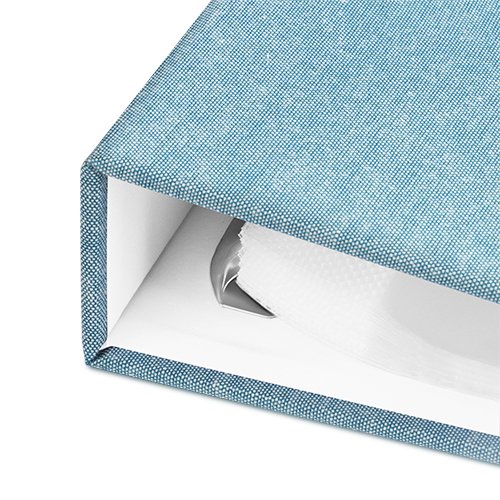 Close-up of a cyan blue 8.5x11 inch 3-ring scrapbook album showing the inside rings and pages.