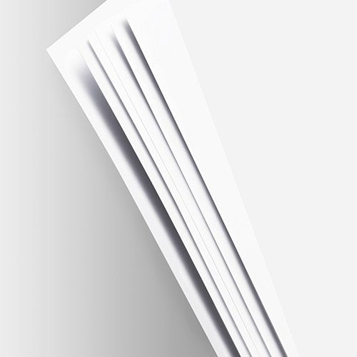Close-up of white pages fanned out in a scrapbook album, showing the edge and thickness of the paper.