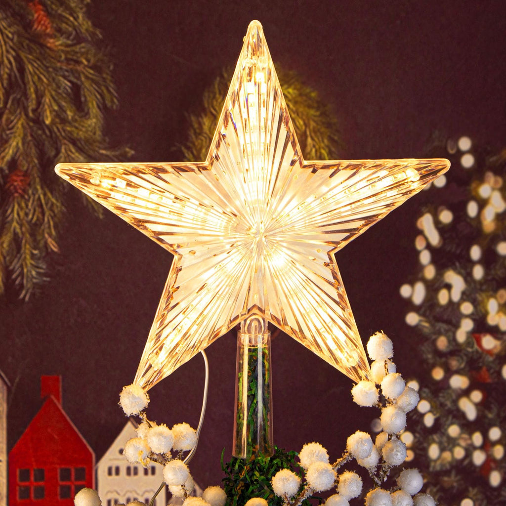 Illuminated star tree topper with ribbed prismatic design and warm white LED lights, decorated with faux snow berries.