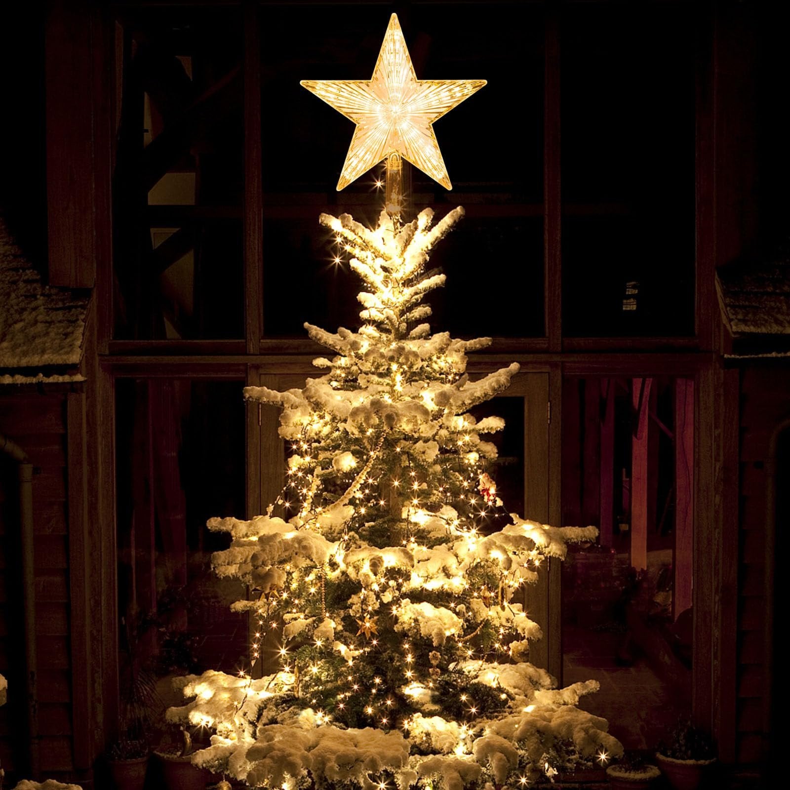 Warm white LED star tree topper with 30 lights on a snow-covered Christmas tree at night.