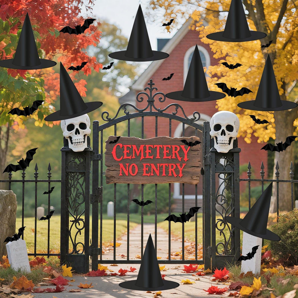 Halloween cemetery gate decorated with witch hats, skulls, and bats, featuring a 'Cemetery No Entry' sign.