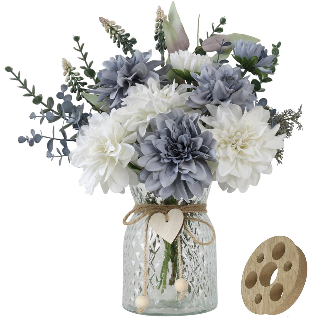 Artificial dahlia flower arrangement in a glass vase with a wooden arranger accessory