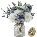 Artificial dahlia flower arrangement in a glass vase with a wooden arranger accessory