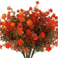 Bundle of artificial fall flowers with orange and yellow blossoms and green-brown leaves, shown from the front.