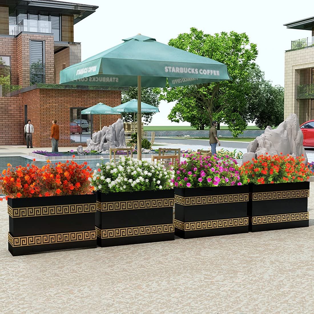 Four black planters with colorful artificial flowers and decorative gold trim, set outdoors near a building and umbrellas.