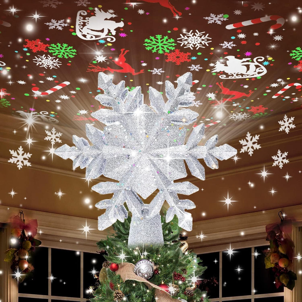Silver snowflake tree topper projecting Christmas patterns onto ceiling above decorated Christmas tree