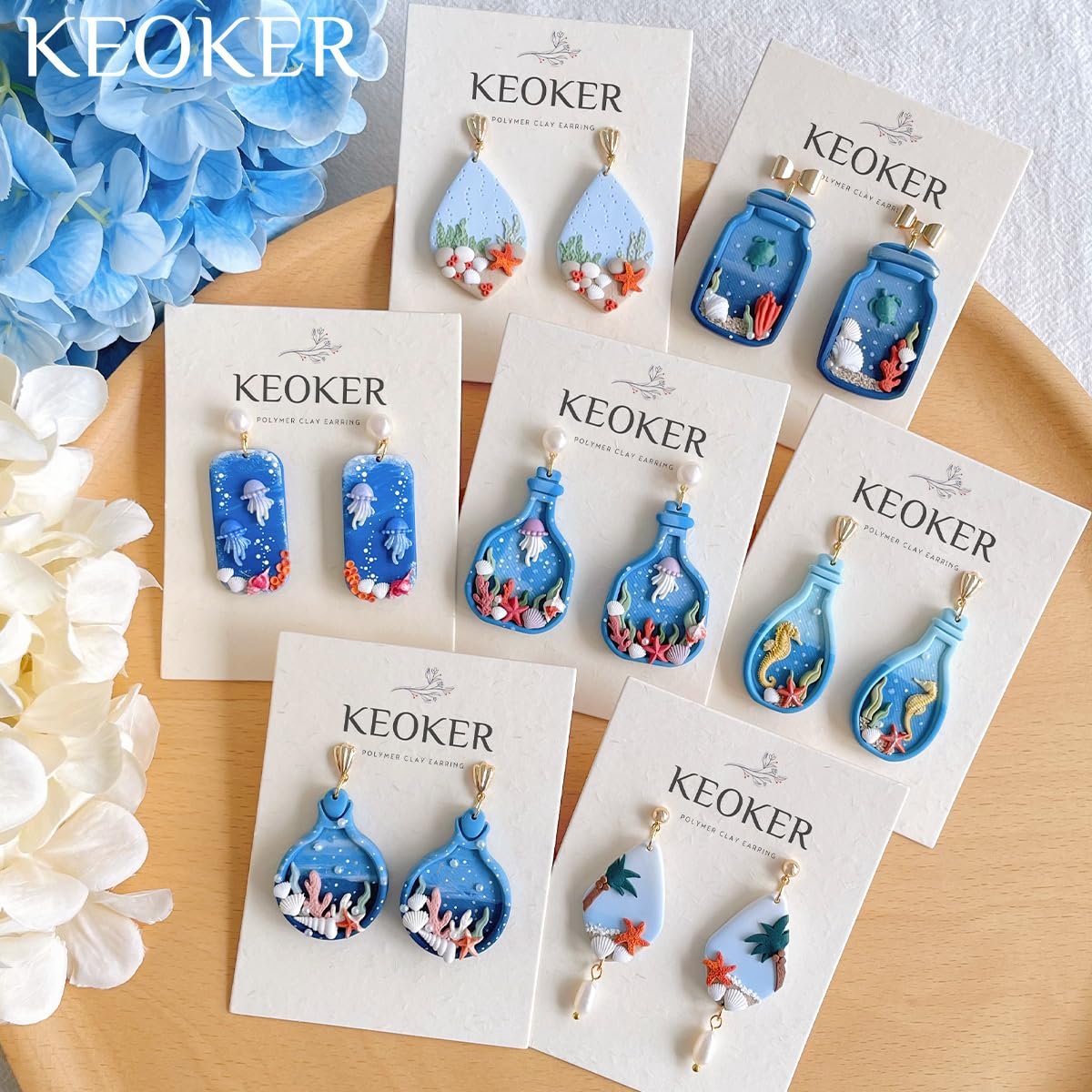 Collection of ocean-themed polymer clay earrings displayed on cards, featuring jellyfish, seahorses, starfish, and coral.