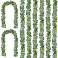 Artificial eucalyptus garland with silk leaves and small white flowers, displayed in multiple strands on a white background.