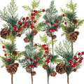 Eight artificial Christmas pine sprigs with red berries and pine cones, arranged in a collage against a white background.