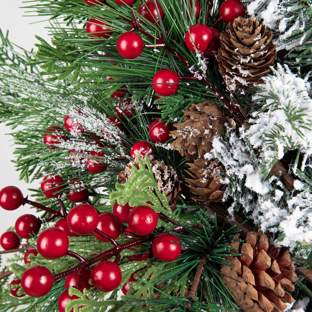Close-up of artificial Christmas picks with red berries, pine cones, and frosted pine needles.