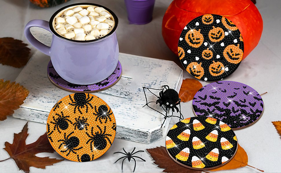 Halloween diamond art coasters with pumpkins, spiders, bats, and candy corn designs, next to a mug of hot chocolate.
