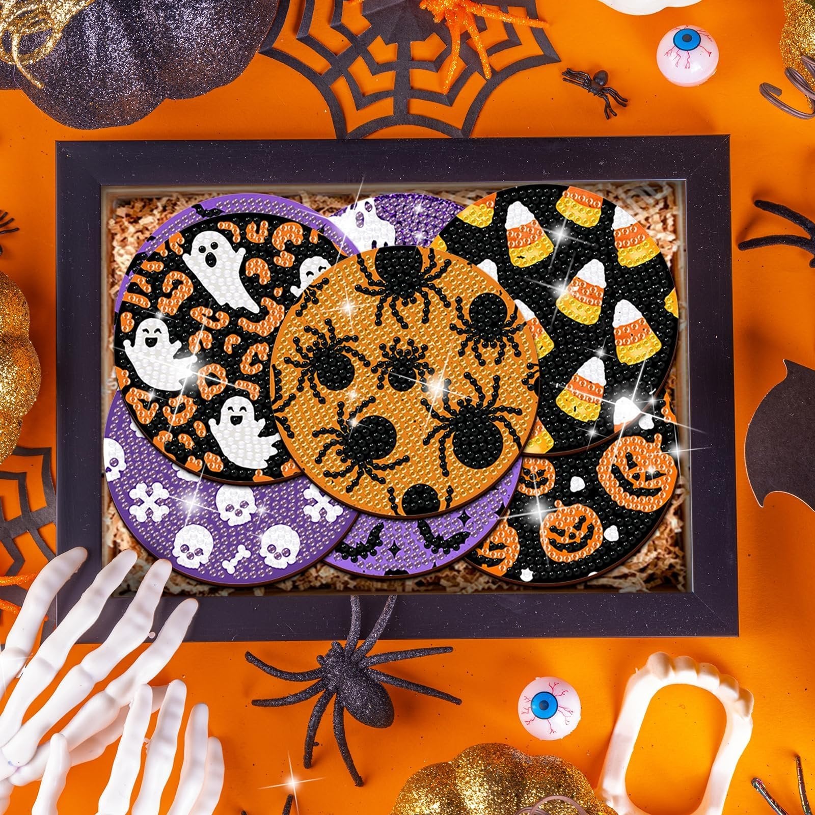 Halloween diamond art coaster kit with ghost, spider, candy corn, and pumpkin designs inside a black frame.