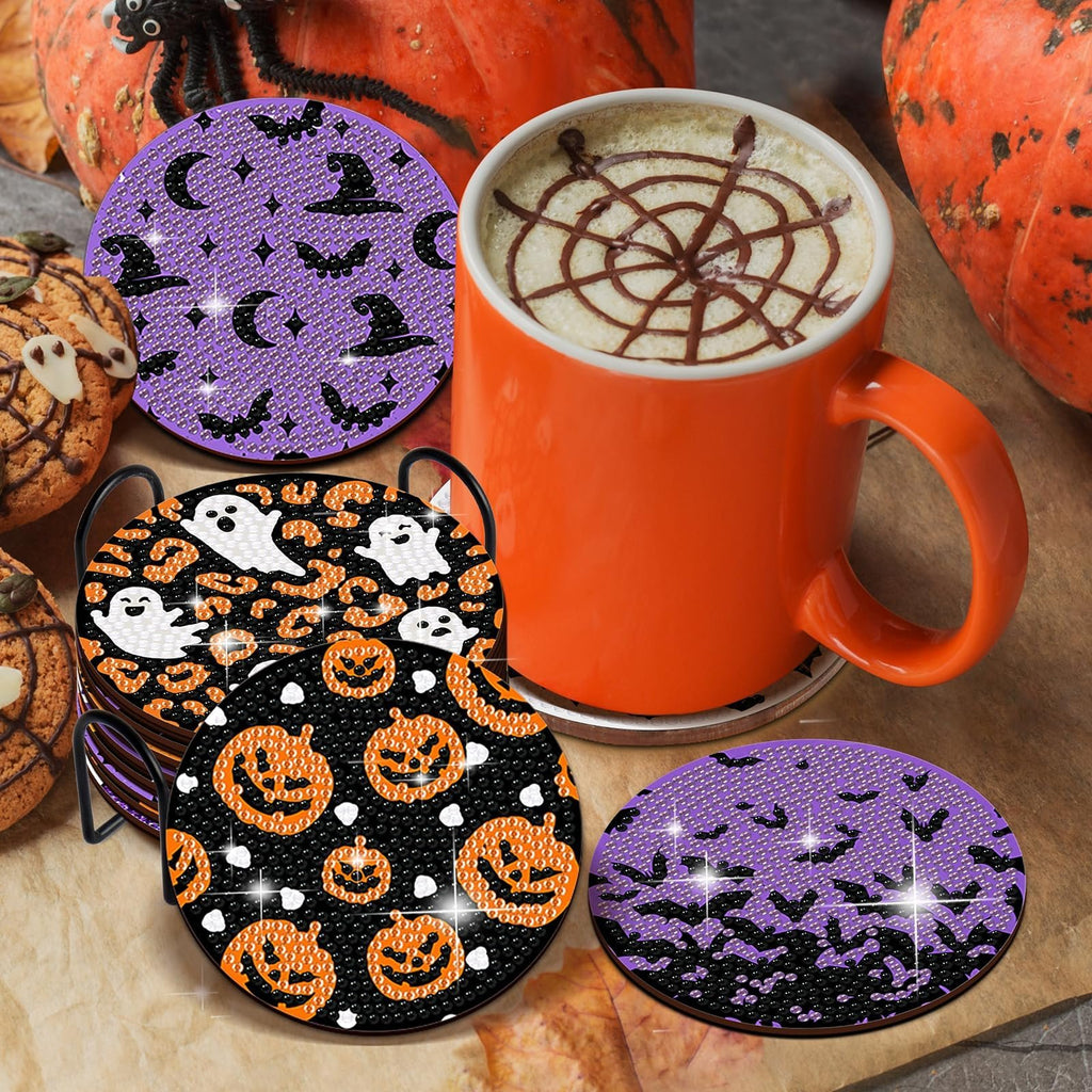 Halloween diamond art coaster kit with holder, featuring pumpkins, ghosts, bats, and witch hats, next to a mug of coffee and pumpkins.
