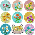 Diamond art coasters with flower designs and a black metal holder, showing various floral patterns.
