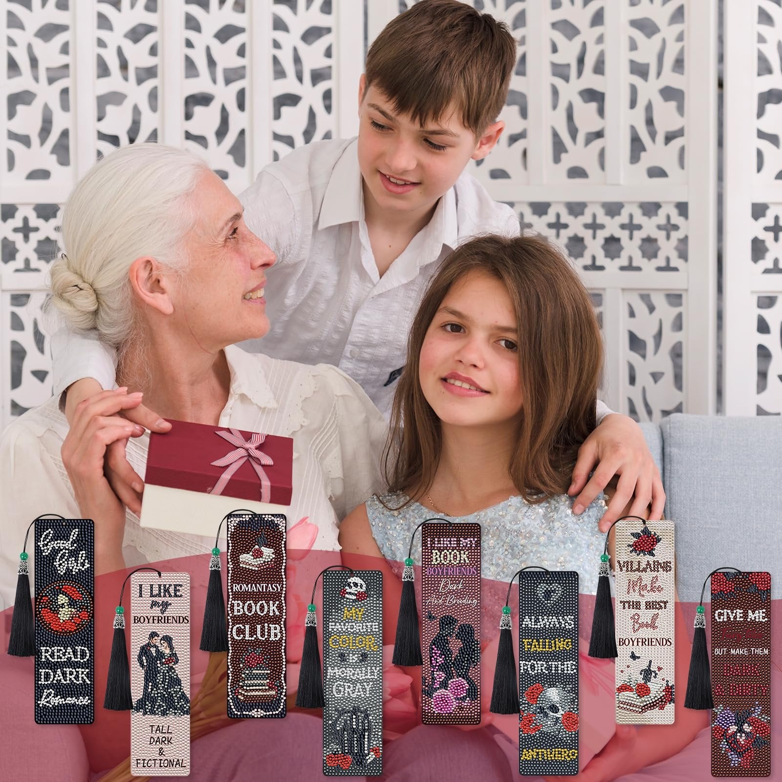 Grandmother and two grandchildren looking at diamond art bookmarks with gothic romance themes