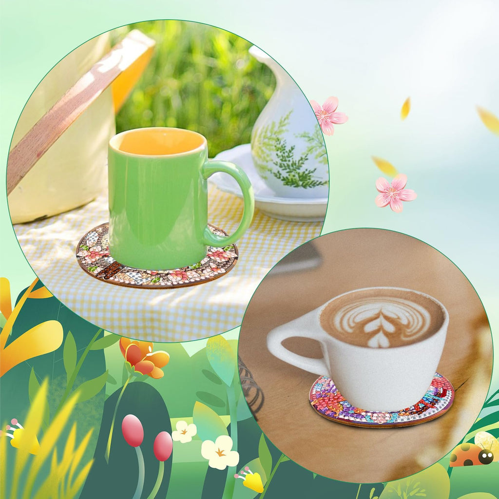 Two diamond painting coasters with floral patterns, one under a green mug on a checkered cloth, the other under a latte cup on a wooden table.