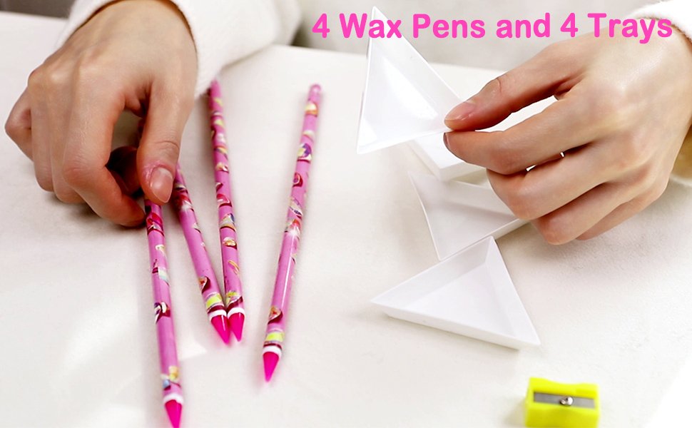 Hands holding pink wax pens and white sorting trays for diamond painting, with a yellow sharpener.