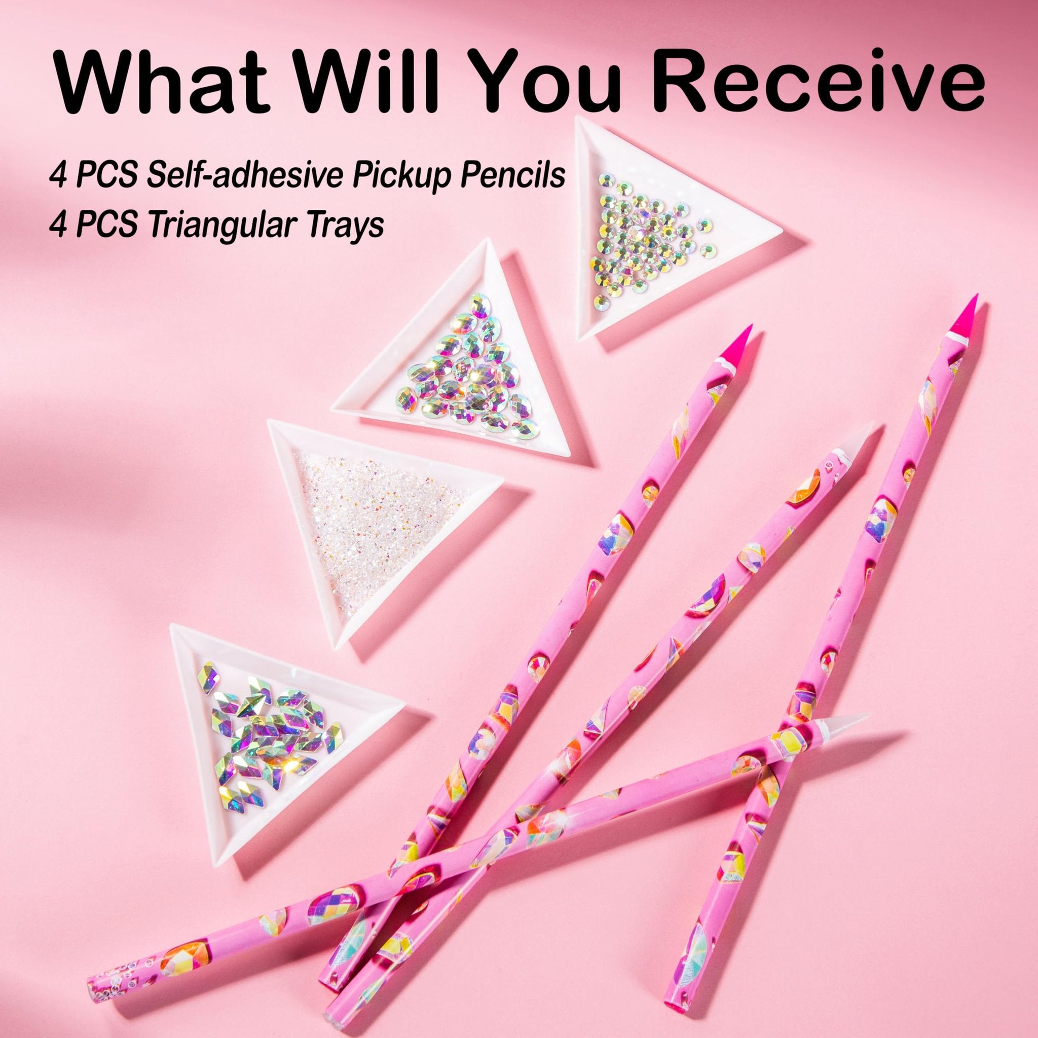 Rhinestone picker tool kit with pink patterned pencils and triangular trays filled with rhinestones on a pink background.