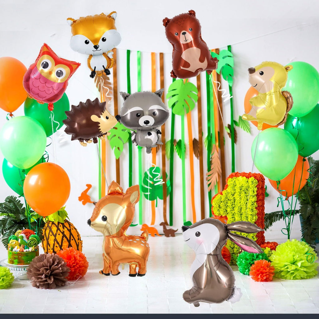 Woodland animal foil balloons including a fox, owl, hedgehog, raccoon, bear, squirrel, deer, and rabbit, with green and orange balloons and a '1' decoration.