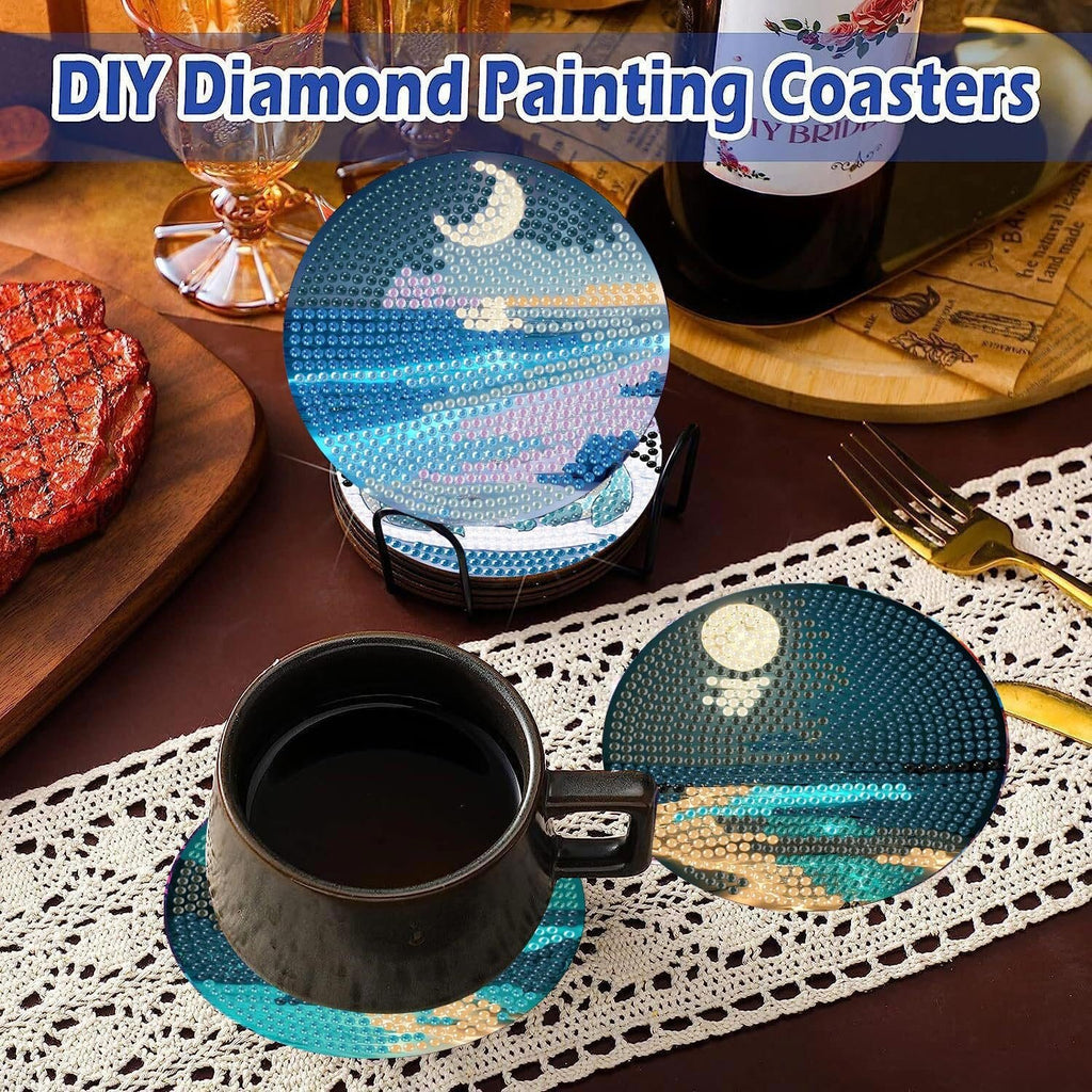 Diamond art coasters with moon and ocean scenes displayed on a table with a cup of coffee and a steak.