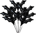 Cluster of eight black bat-shaped foil balloons with white star pattern, tied with black ribbons.