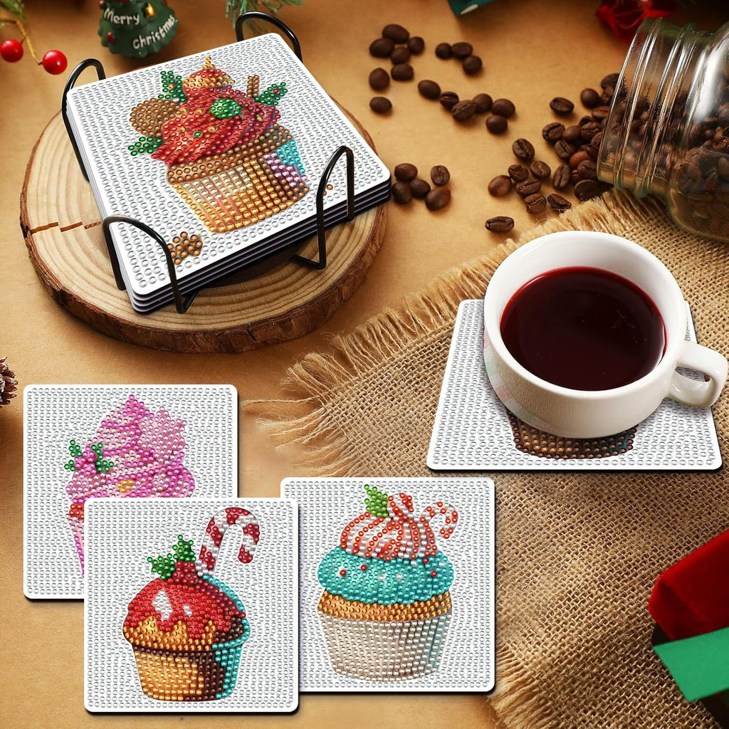 Diamond art painting coasters with Christmas cupcake designs and holder, plus one coaster under a coffee cup.