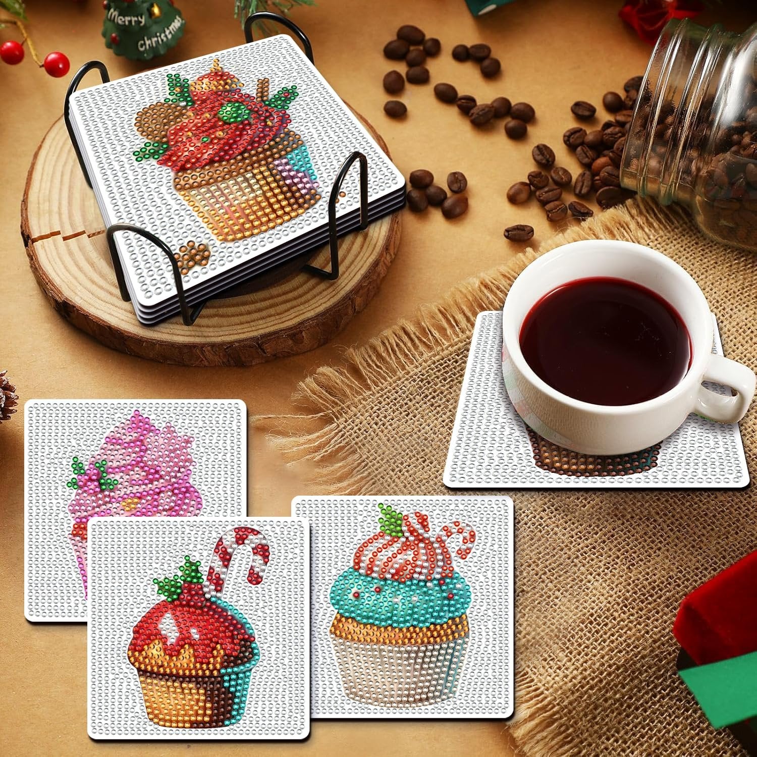 Diamond art painting coasters with Christmas cupcake designs and holder, plus one coaster under a coffee cup.