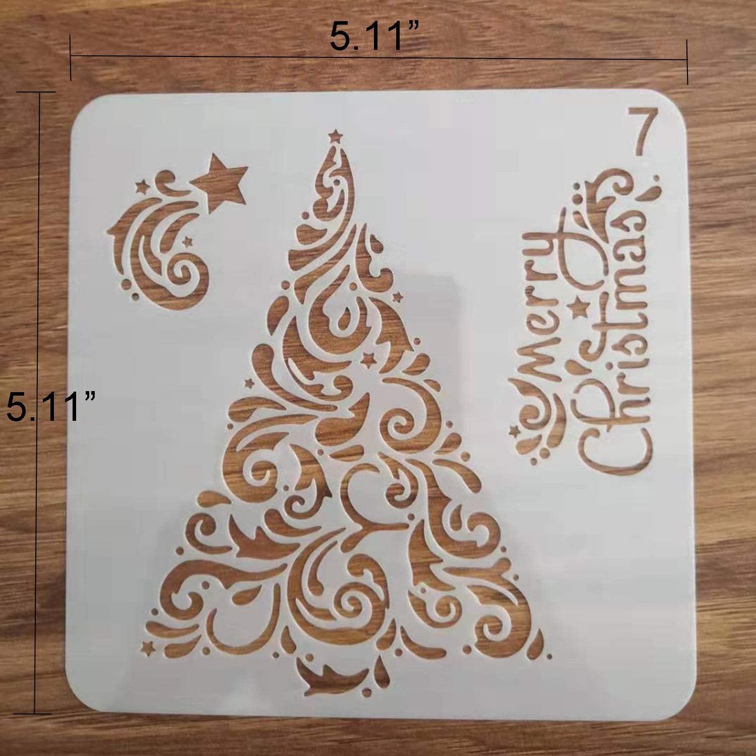 Christmas tree stencil with swirling ornate branches and a star, reads 'Merry Christmas'.