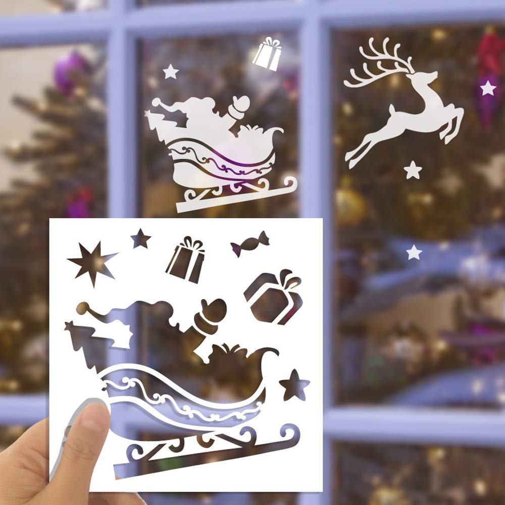 Christmas stencil set with Santa in a sleigh, reindeer, gifts, and stars, held by a hand against a window view of a Christmas tree.