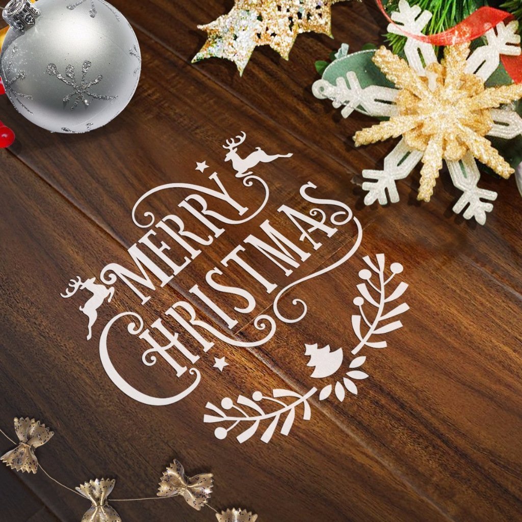 Christmas stencils with 'Merry Christmas' text and festive icons on a wooden background with ornaments