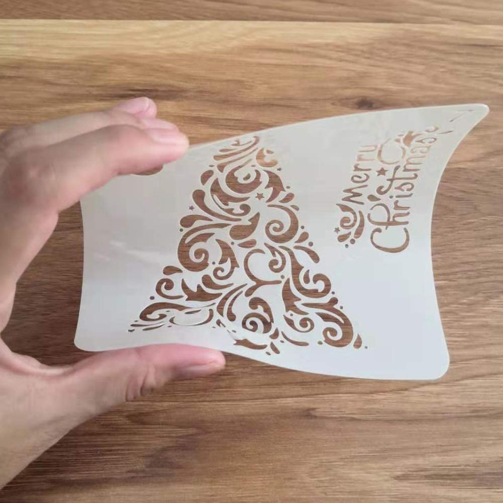 Christmas tree stencil with ornate swirls and 'Merry Christmas' text held by a hand