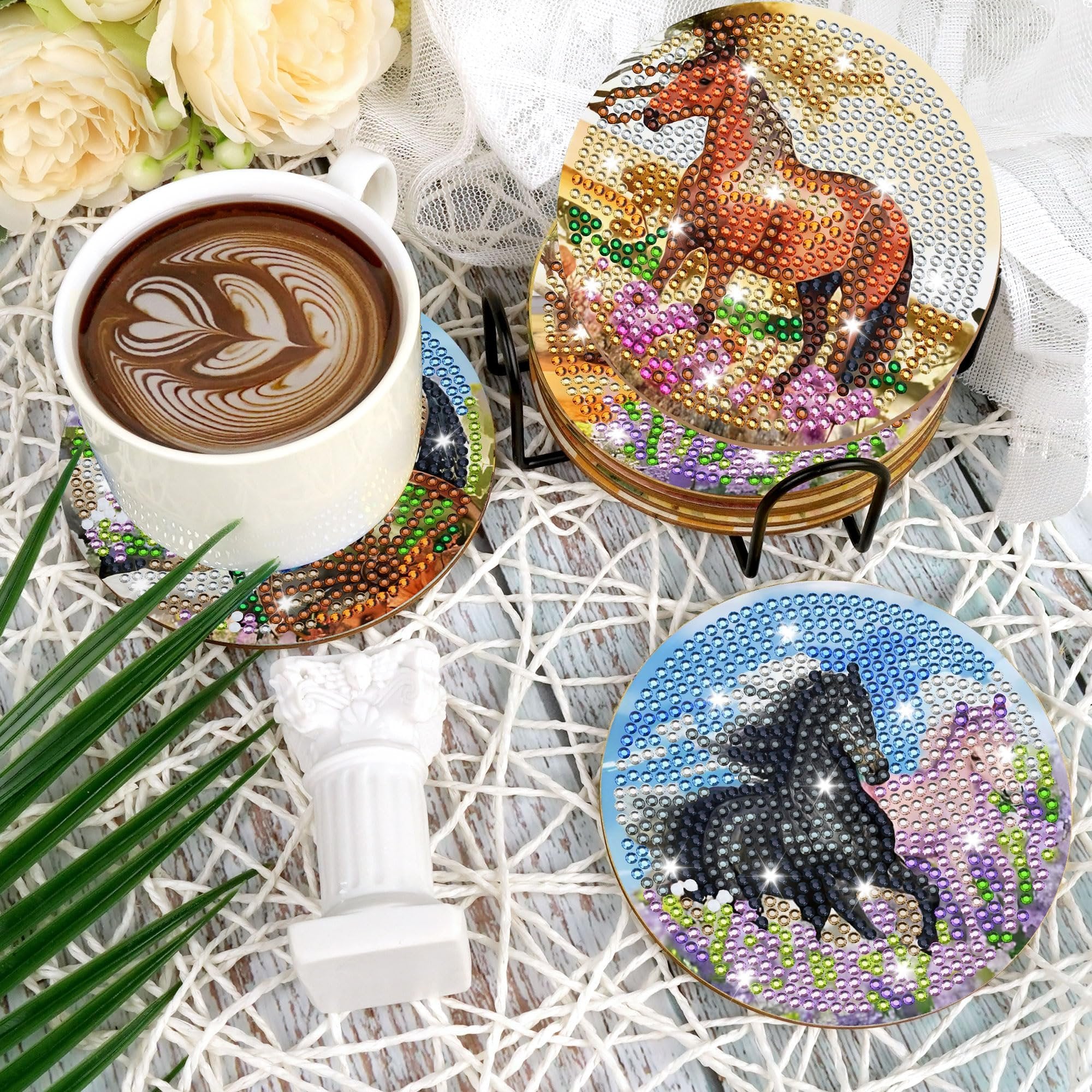 Diamond art horse coasters with holder and a cup of coffee on a white woven placemat