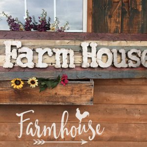 Farmhouse sign with decorative flowers and a rooster graphic on a wooden wall.