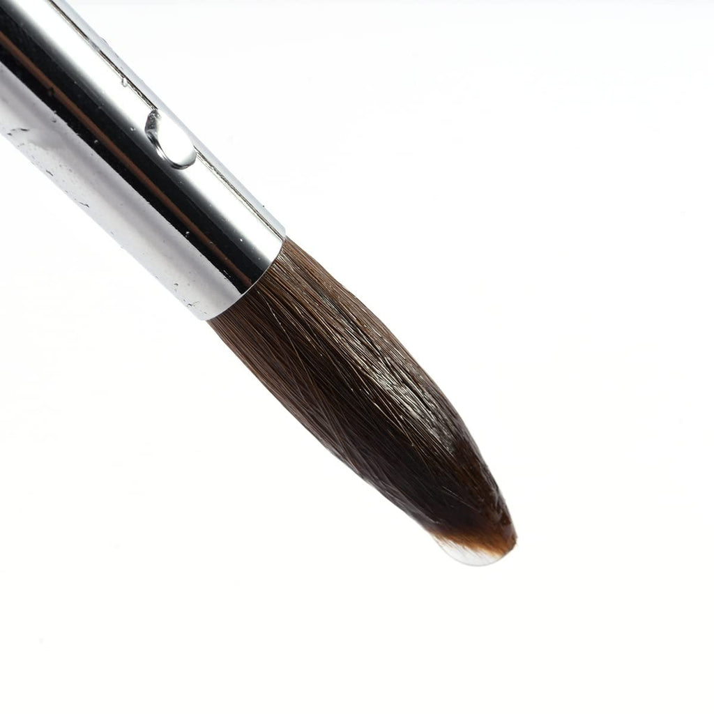 Close-up of a sable watercolor brush with a metal ferrule and a pointed tip, showing a drop of clear liquid.