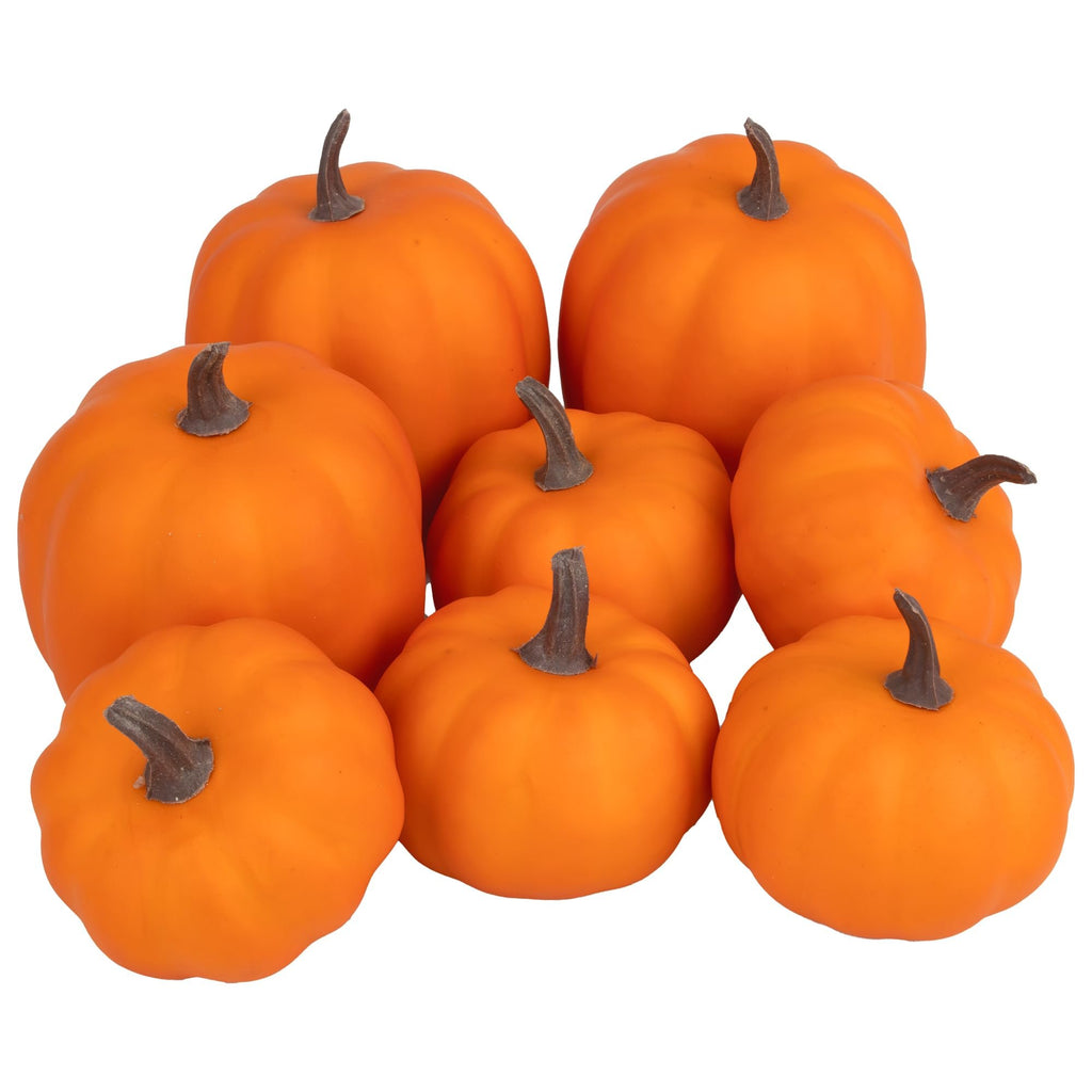 Group of eight artificial orange foam pumpkins with brown stems on a white background