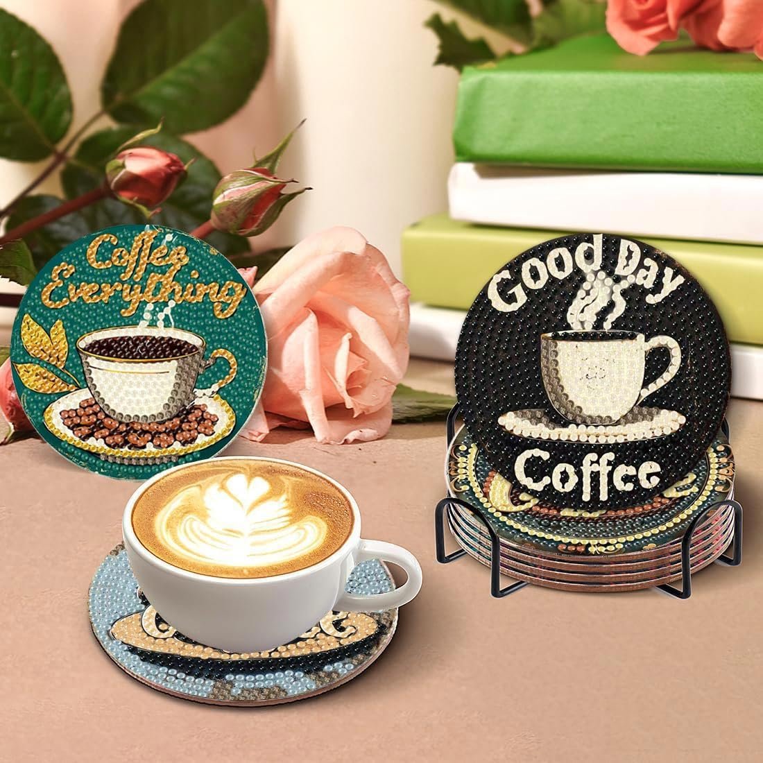 Diamond art coffee coasters with holder and a cup of latte, surrounded by roses and books.