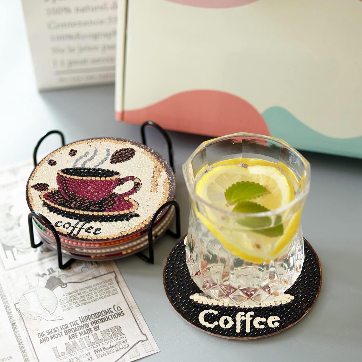 Diamond art coffee coasters in a holder next to a glass of lemonade, with vintage shoe advertisements.
