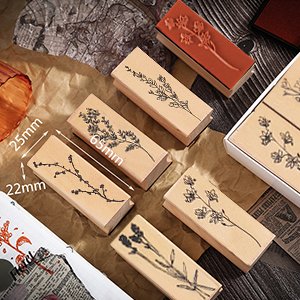 Set of 8 wood mounted rubber stamps with plant and flower patterns, arranged on brown paper.