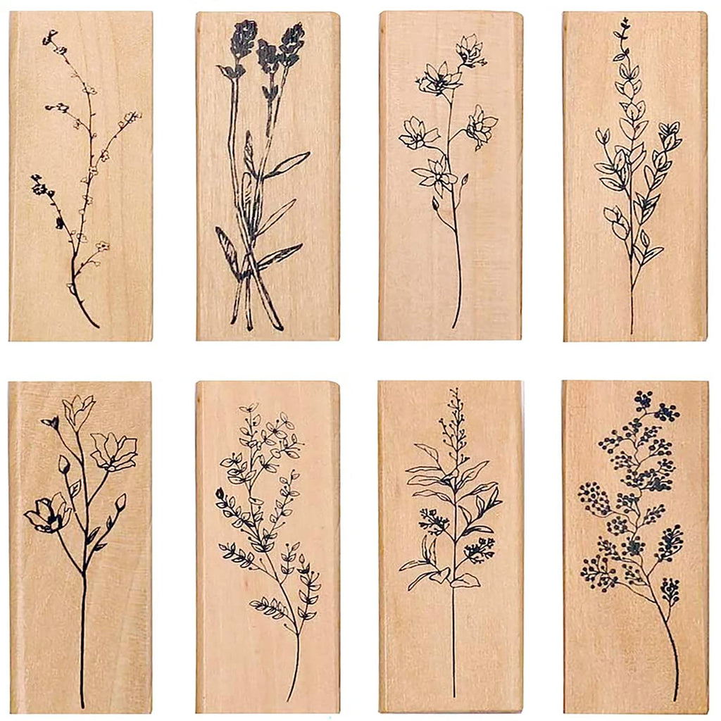 Eight wood-mounted rubber stamps featuring delicate line drawings of plants and flowers, arranged in a 2x4 grid.