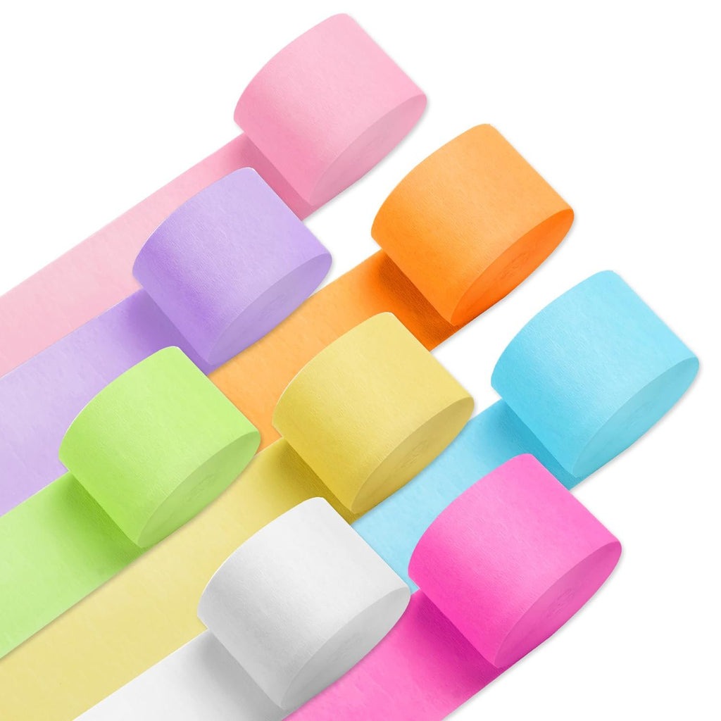 Eight rolls of crepe paper streamers in pastel and bright colors arranged diagonally on a white background.