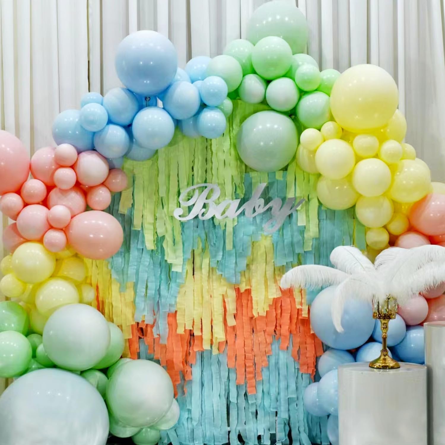 Balloon arch and fringe backdrop with 'Baby' cutout for a party decoration