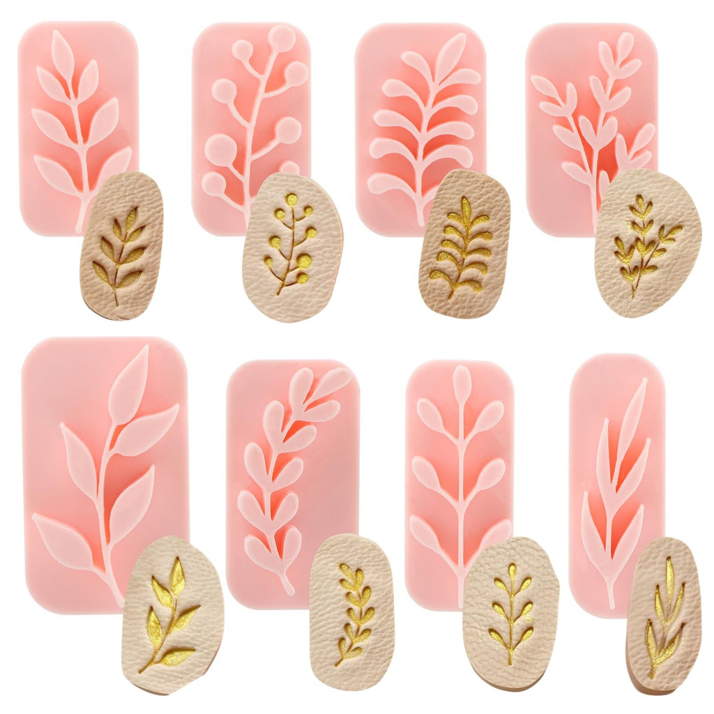 Set of eight botanical polymer clay stamps and cutters with leaf and branch designs in pink and gold.