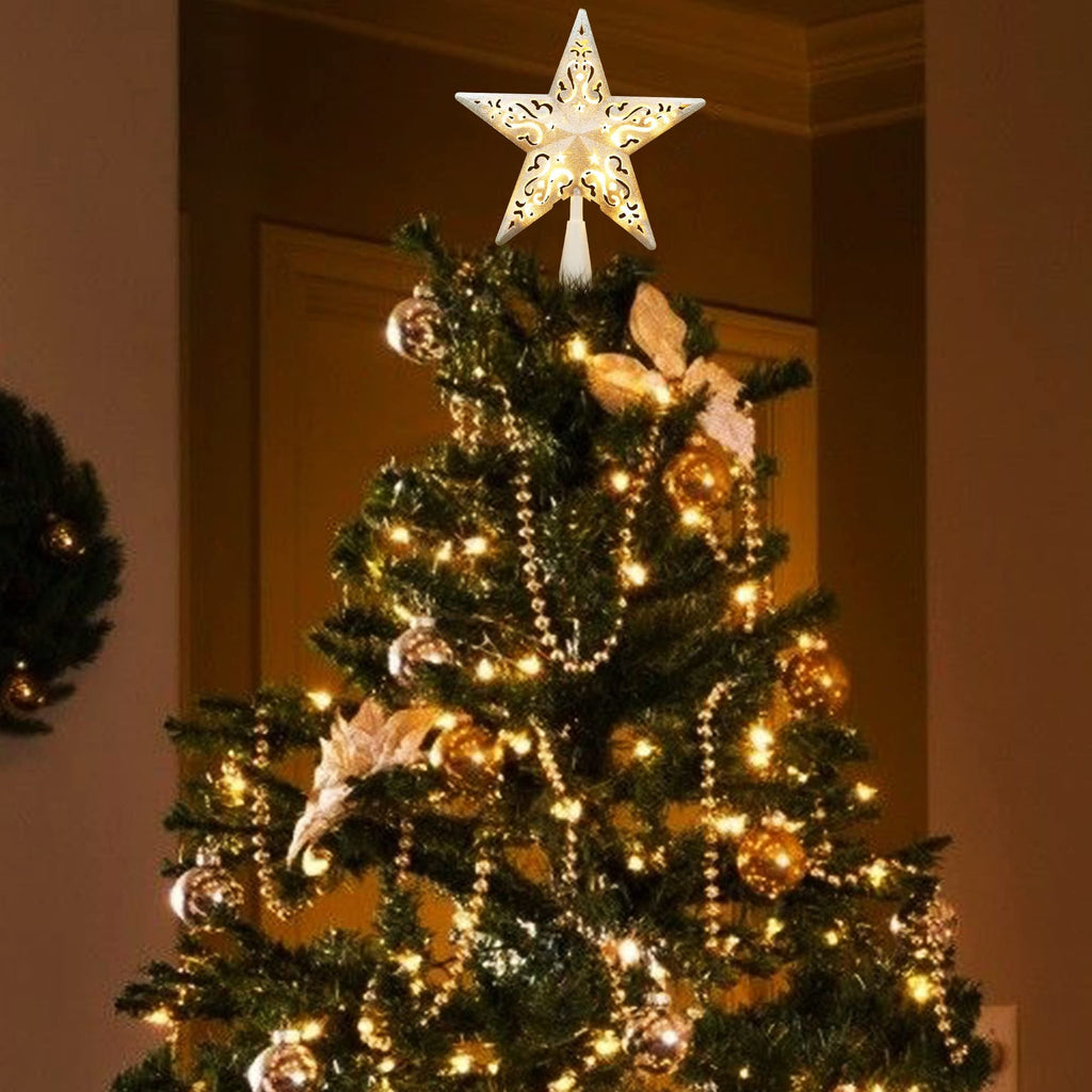 Silver glittered hollow-out star Christmas tree topper with warm white lights on a decorated tree