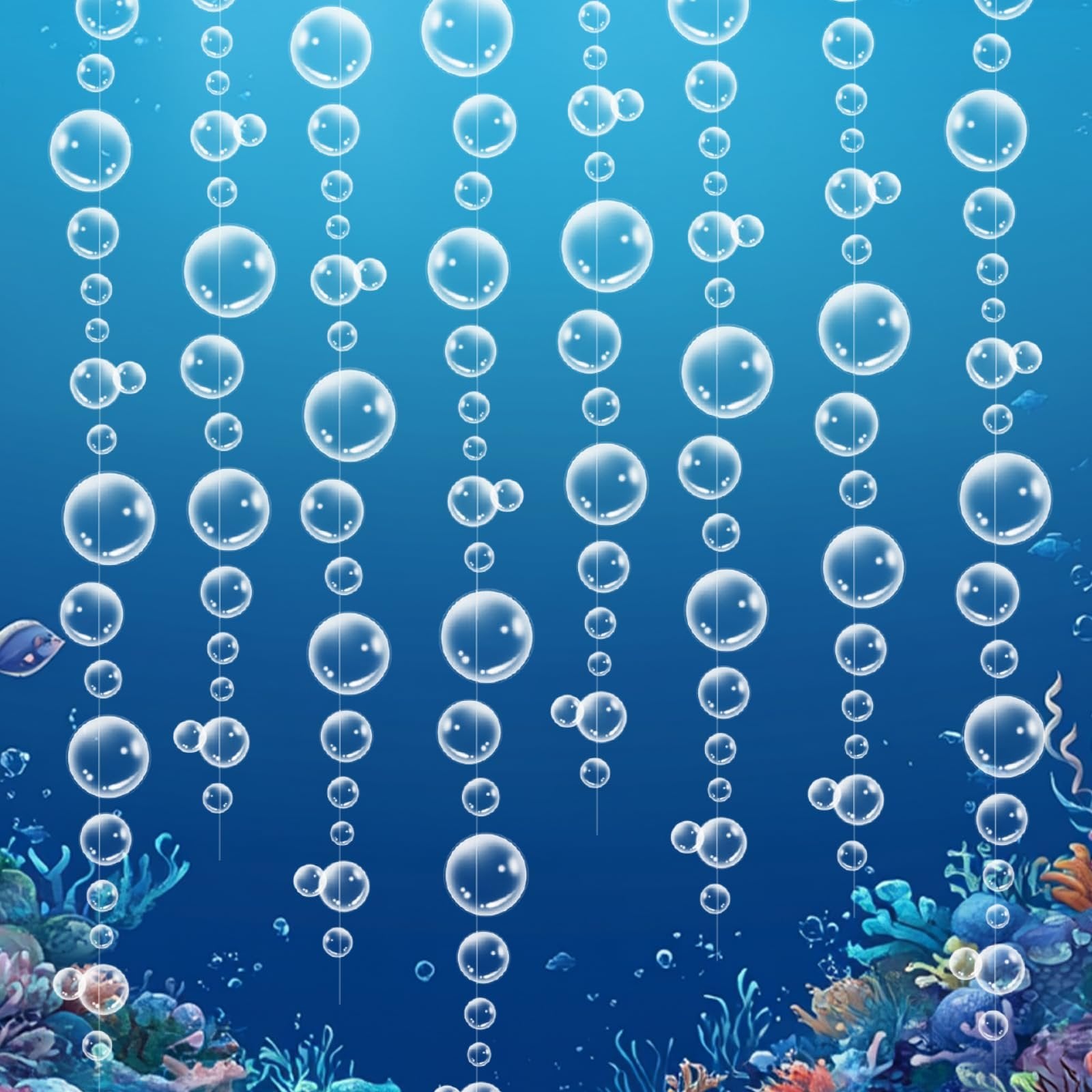 Underwater scene with multiple strands of clear bubble garland hanging against a blue background with coral and fish.