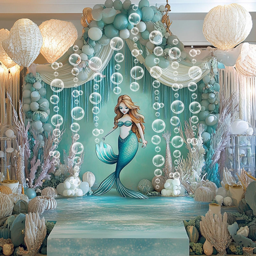 Mermaid-themed party backdrop with balloons, bubble garlands, and a mermaid illustration.