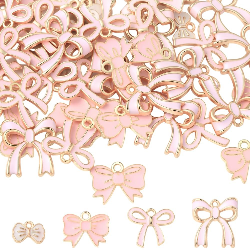 Collection of pink enamel bow charms with gold trim, shown from multiple angles and sizes.