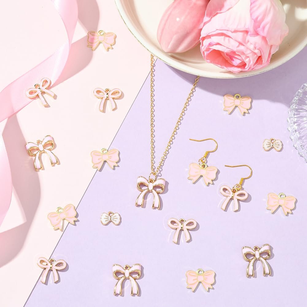 Pink enamel bow charms and jewelry set on a pastel background with pink ribbon and flowers