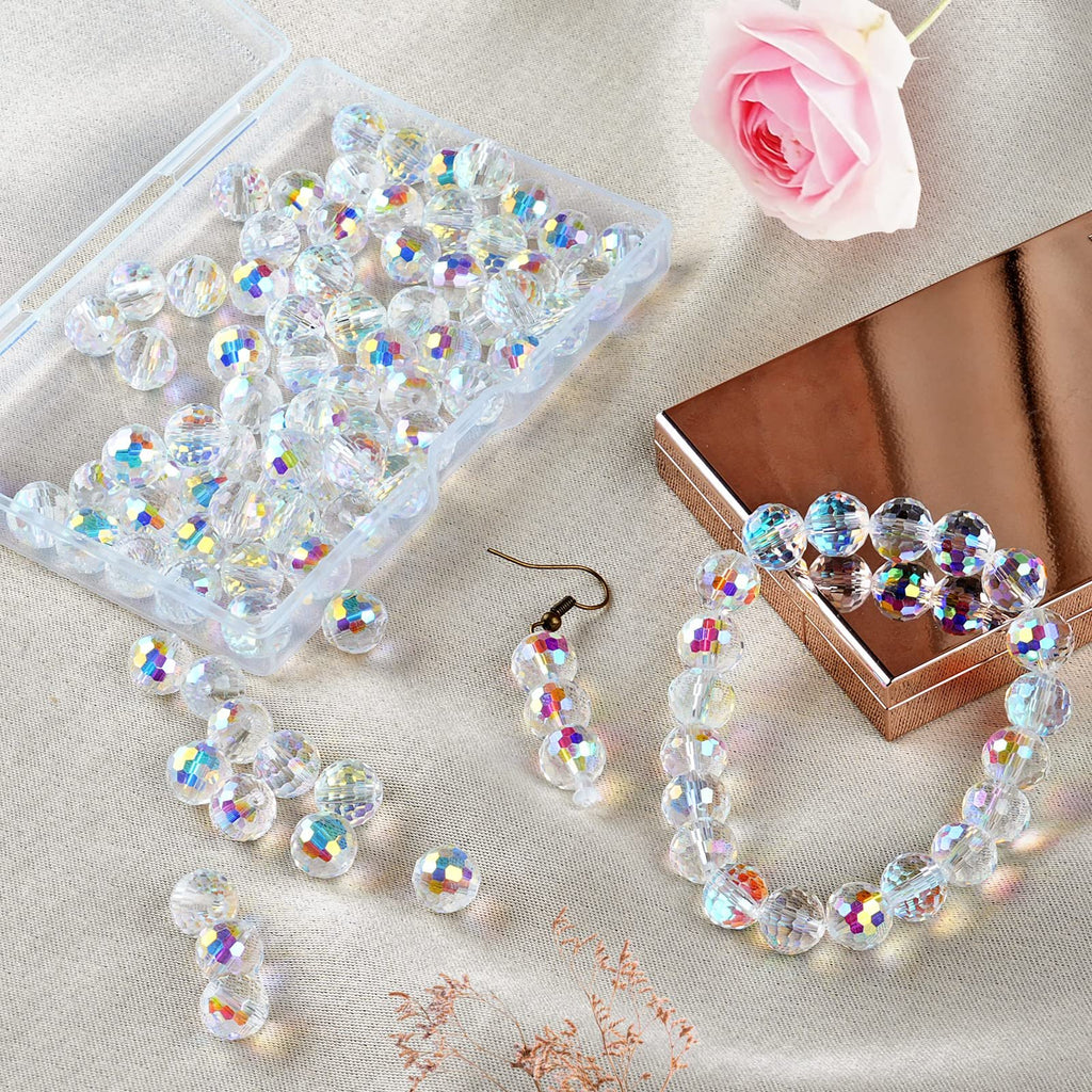 Clear faceted glass beads in a plastic container and scattered, with a bracelet and earring made from the beads.